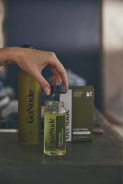 Pouring Go Nude Everything Surface Cleaner concentrate into the Keeper bottle