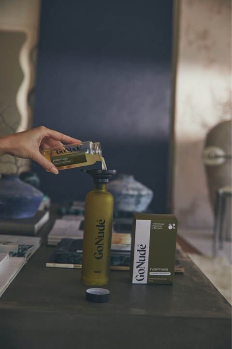 Pouring Go Nude Everything Surface Cleaner concentrate into the Keeper bottle