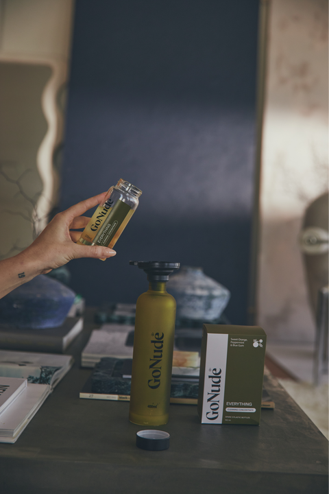 Pouring Go Nude Everything Surface Cleaner concentrate into the Keeper bottle